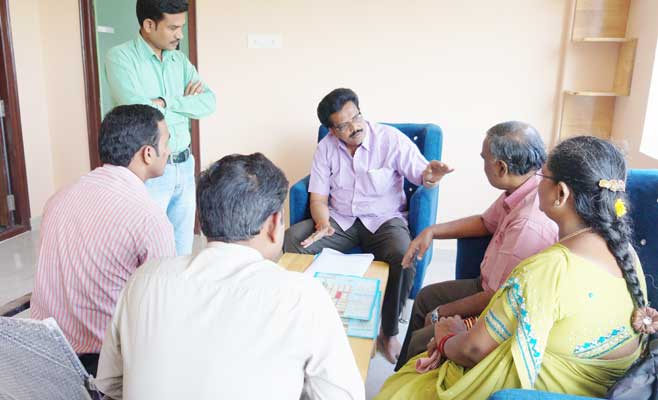 Explaining to customers about Akshaya Gardens in Mela